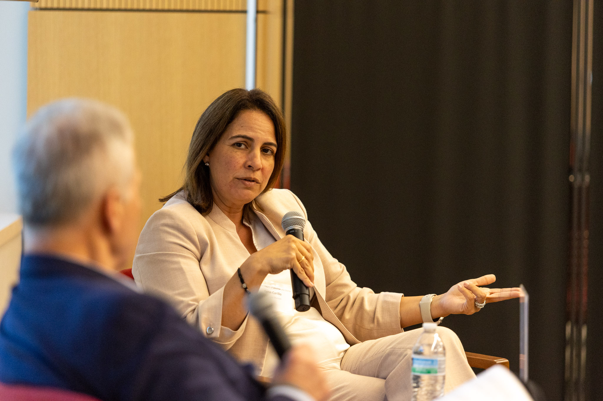 Speaker presenting at podium during UH Law conference